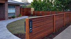 a wooden fence in front of a house