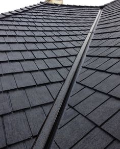 the side of a building with black shingles