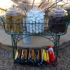 a wire basket filled with lots of different types of candies on top of a table