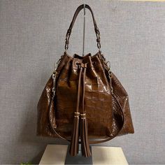 Coach Madison Croc Embossed Large Drawstring Shoulder Bag F26341. Croc-Embossed Leather, Cognac Color, Inside Zip, Cell-Phone And Multifunction Pockets, Drawstring Closure, Fabric Lining, Handle With 9” Drop, Longer Strap With 17” Drop For Shoulder Wear. Approximate Measurements: 17”L X 14.5”H X 6.75”W. Excellent Condition. Clean And No Smoke/Pet Smell. Looks Like Brand New But Can’t Confirm. Please See All Pictures For Details As They Are Part Of The Description. Please Message With Questions A Luxury Bucket Shape Hobo Bag For Errands, Luxury Bucket Hobo Bag For Errands, Luxury Brown Pouch Hobo Bag, Luxury Coach Bucket Bag With Detachable Strap, Luxury Coach Bucket Bag With Detachable Handle, Coach Brown Leather Bucket Bag, Coach Bucket Bag With Detachable Handle, Coach Luxury Bucket Bag For Errands, Coach Bucket Bag For Errands