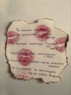 a piece of paper that has some writing on it with red lipstick imprints on it