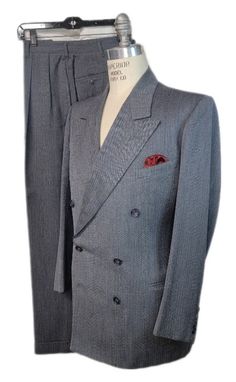 "Here for your consideration is this beautiful Herringbone 100 % wool suit. Beautiful hourglass shape, comes with Intricate Herringbone pattern in a gray blue tone, just stunning. Please view photos as they are part of the description.  Label reads: Garfield \"ACE\", Tailored at Mayfield. Measurements Coat:  Shoulders 18\" Chest 42\"  Sleeves 24\" Length 30 1/2\" Pants: Waist 32 + 2\" Inseam 30\" Outseam 42\" Cuffs 1 3/4\"  Hem 1\" Cuff width 9 1/2\" Approximate size 40R Condition: Trouser have Classic Gray Double Breasted Suit With Notch Lapel, Classic Gray Tailored Double Breasted Suit, Timeless Fitted Gray Suit, Tailored Gray Double Breasted Suit, Tailored Gray Formal Sets, Fitted Gray Double Breasted Suit For Semi-formal Occasions, Gray Wool Suits With Notch Lapel, Tailored Gray Sets For Formal Occasions, Gray Double Breasted Suit For Formal Occasions