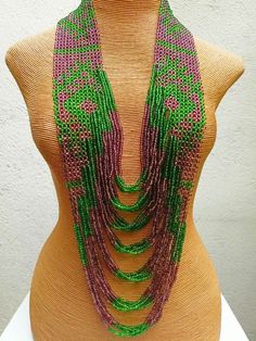 A piece made in collaboration with the T'boli tribe of Mindanao. Unique Green Necklace With 108 Beads, Traditional Green Long Necklace Beads, Long Traditional Green Necklace, Green Polished Beads Necklace For Festivals, Green Polished Beaded Necklace For Festival, Green Oval Beads Beaded Necklaces, Unique Multi-strand Polished Beads, Unique Green Beaded Necklace With Oval Beads, Green Oval Beads Necklace