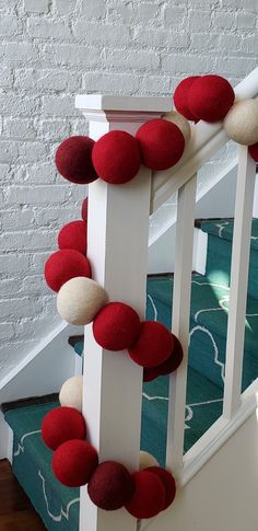 red and white felt garland on the banister