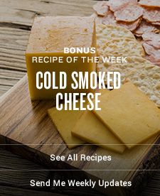 a wooden cutting board topped with cheese and crackers