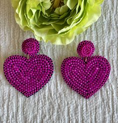 Seed beaded belt heart shaped earrings.Approximately 2.5" L x 2" W Purple Heart Beads Jewelry For Party, Heart Shaped Beaded Earrings For Party, Pink Heart Beads Earrings For Party, Pink Beaded Heart Earrings For Valentine's Day, Pink Heart-shaped Beaded Earrings, Pink Heart Beads Earrings For Valentine's Day, Pink Beaded Heart Earrings For Party, Pink Heart-shaped Beaded Earrings For Parties, Trendy Purple Heart Earrings