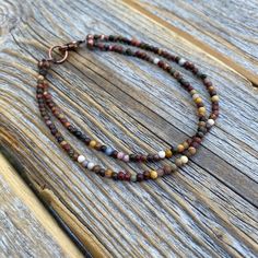 Tiny Red Creek Jasper Beaded Anklet or Bracelet: This boho chic ankle/bracelet is perfect for all occasions. The various shades of color make this a very versatile piece of jewelry that will go with many different outfits. Dress up or down! Materials: * Red Creek Jasper Beads - 2mm * Easy to Use Copper Lobster Clasp Choose your length at checkout! Matching Necklace: https://www.etsy.com/listing/960287596/small-beaded-necklace-red-creek-jasper Bohemian Brown Bracelet With Tiny Beads, Adjustable Double Strand Bracelets With Colorful Beads, Brown Gemstone Beads Bracelets For Festival, Brown Gemstone Beaded Bracelets For Festival, Adjustable Double Strand Colorful Beads Bracelet, Festival Brown Beaded Bracelets With Gemstone, Adjustable Brown Beaded Anklets, Colorful Beads Double Strand Bracelet, Festival Brown Gemstone Beaded Bracelets