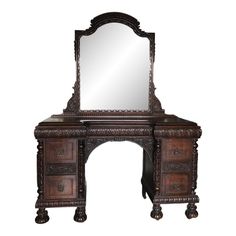 an ornate wooden desk with mirror and drawers