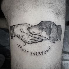 a black and white photo of a dog holding another dog's hand with trust everyone written on it