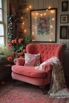 a living room filled with lots of furniture and flowers on the wall next to a window