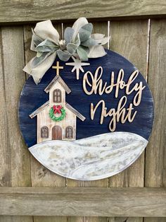 a wooden sign with a house and wreath on it that says, she's night