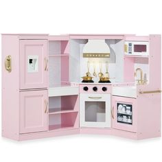 a pink play kitchen with white appliances and gold accents on the doors, shelves, and drawers