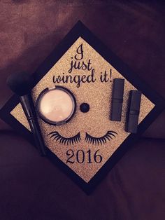 a graduation cap with makeup and eyeliners on it that says i just winged it