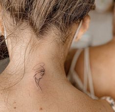 a woman with a small tattoo on her neck