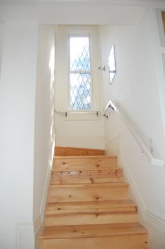 a wooden staircase leading up to a window