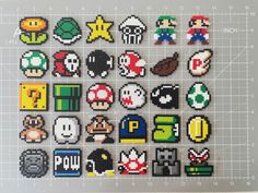 an array of pixelated video game characters are displayed on a sheet of graph paper