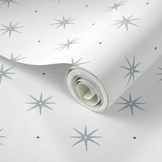 a white wallpaper with blue and red stars on the background, as well as a roll of paper