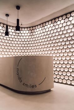 a circular counter in front of a white wall with circles on it and the words smile written below