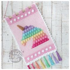 an image of a cross stitch pattern for a unicorn pin cushion with tassels