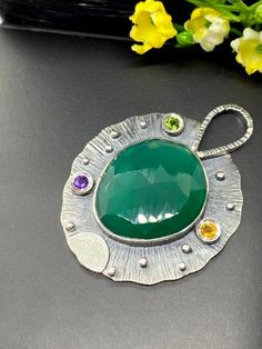 "Artisan Green Onyx gemstone pendant in sterling silver Hand-made Sterling Silver 925 Stones used: Faceted Green Onyx, Chrome Diopside, Amethyst, Citrine Height - 1 7/8\" (with bail), Width - 1 3/8\" Unique Handcrafted One-of a-kind Design Pendant Each Piece of Jewelry in my Collection is Absolutely One of a Kind! When you start wearing a piece of my jewelry you will fall in love with it more and more each day and feel that good Energy and Love that I pass into it while creating this piece of Ar London Blue Topaz Ring, Onyx Gemstone, Handcrafted Rings, Metal Work, Unique Gemstones, Green Onyx, Good Energy, Unique Earrings, My Collection