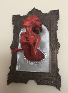 a mirror with a woman's body painted on it