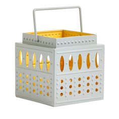 a white basket with yellow handles and holes on the sides, sitting against a white background