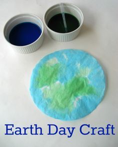 the earth day craft is made with blue and green paper plates, two cups of water and