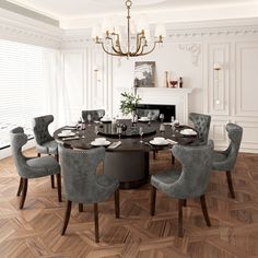 a dining room table with grey chairs around it