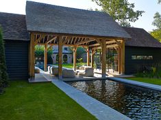 an outdoor living area with a pond and pavilion