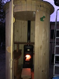 a small wood burning stove in a shed