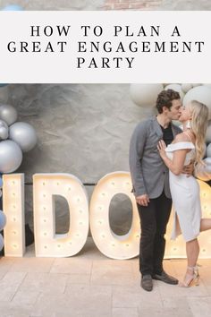 a man and woman kissing in front of balloons with the words how to plan a great engagement party