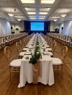 an empty banquet hall with long tables and chairs