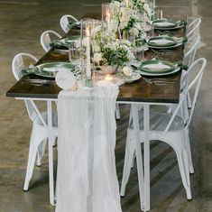 the table is set with white and green place settings