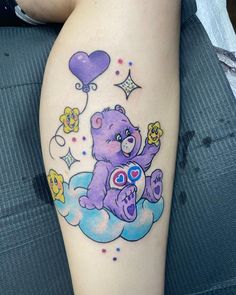 a purple teddy bear sitting on top of a cloud with hearts and stars around it