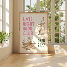 an open book club sign in front of a window with a glass and bottle on it