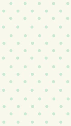 a white and green polka dot wallpaper with light blue dots on the back ground