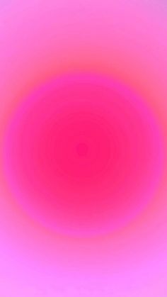 an image of a red and pink circular object in the middle of a blue sky