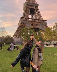 two women standing in front of the eiffel tower