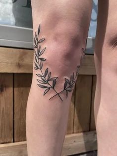 two people with tattoos on their legs and one has a branch tattoo on the leg