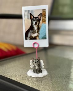 a small dog figurine with an angel on it