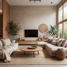 a living room filled with furniture and a flat screen tv mounted on a wall above a wooden coffee table