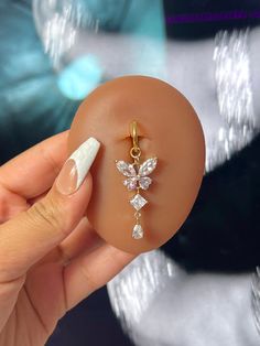 a person holding an object in their hand with some diamonds on it's side