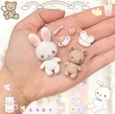 a person's hand holding several small toy animals