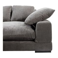 a gray couch with two pillows on it's back and one arm facing the camera