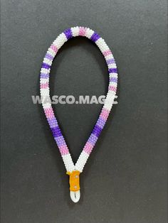 a beaded lanyard with an orange, white and purple ribbon on it's end