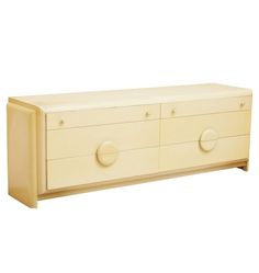 a white dresser with three drawers and two knobs