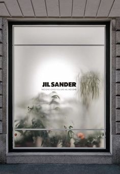 a window display with the words jil sander on it's front and side