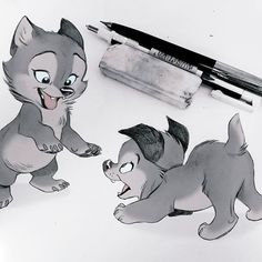 an image of two cats playing with each other on the table next to a pen and paper