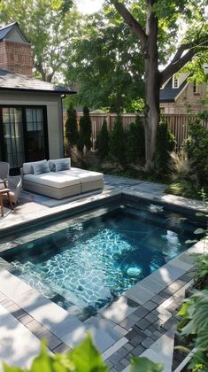 a backyard with a pool, patio and outdoor living area in the middle of it