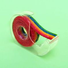 there is a roll of tape that has been made to look like a rainbow ribbon